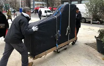 two men moving a piano