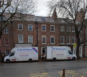 2 A&M removals vans outside a house in the centre of York