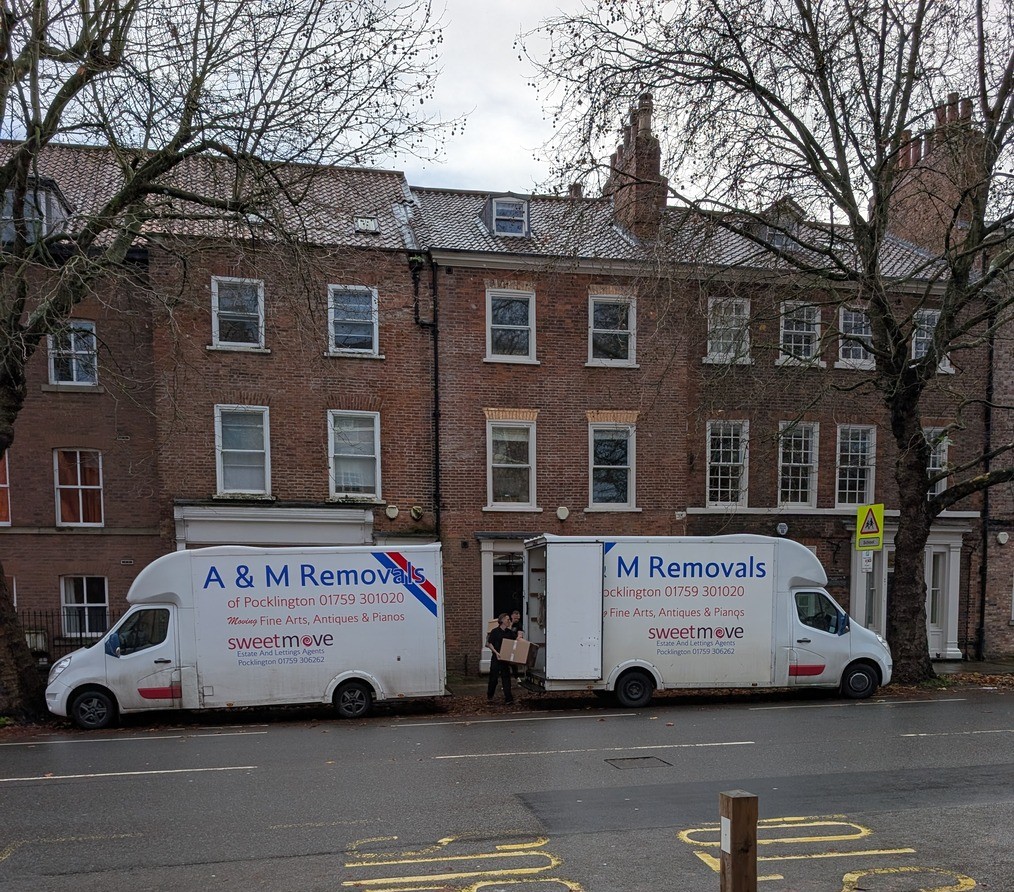 2 A&M removals vans outside a house in the centre of York