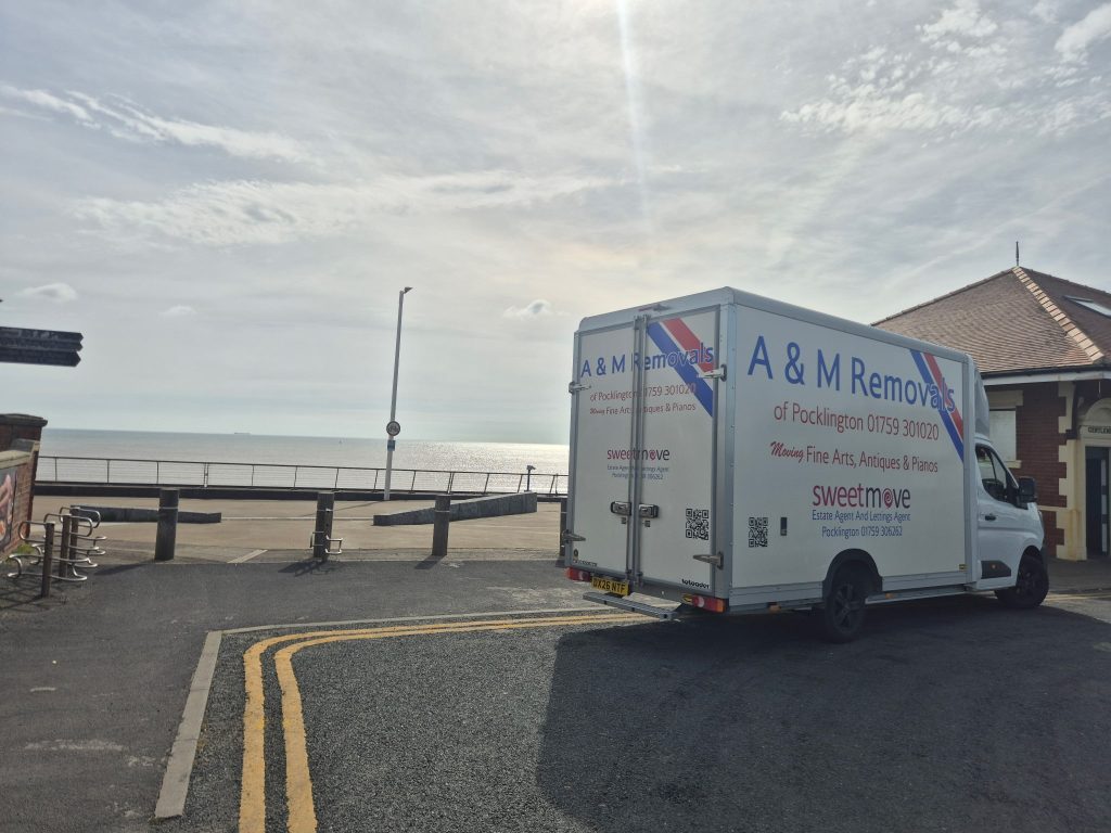 A removal van by the sea in Hornsea | A&M Removals