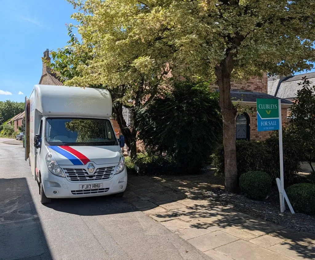 An A&M Removals van outside a house