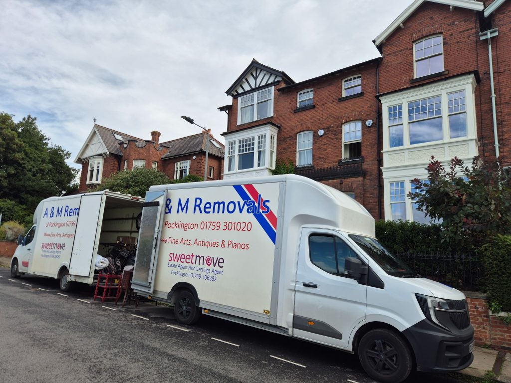 2 A&M Removals vans outside a house in York