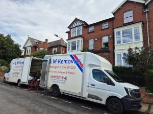 2 A&M Removals vans outside a house in York
